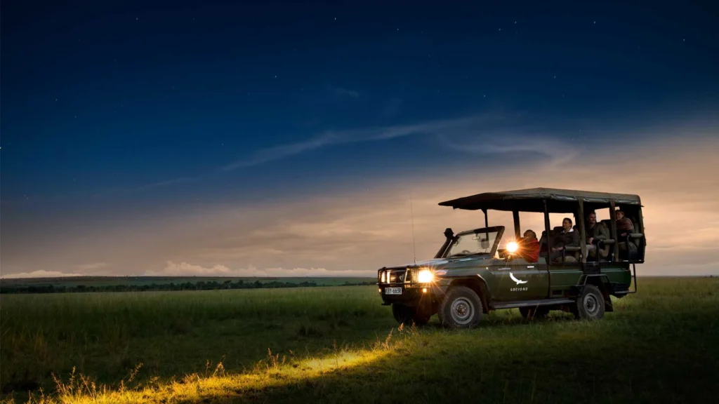 A safari vehicle using spotlights on a thrilling serengeti night game drive.