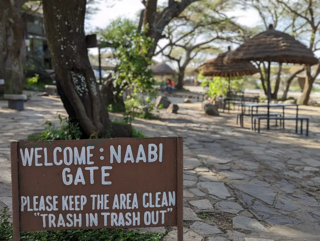 Naabi Hill Gate entrance sign showing how to get to Serengeti by land.