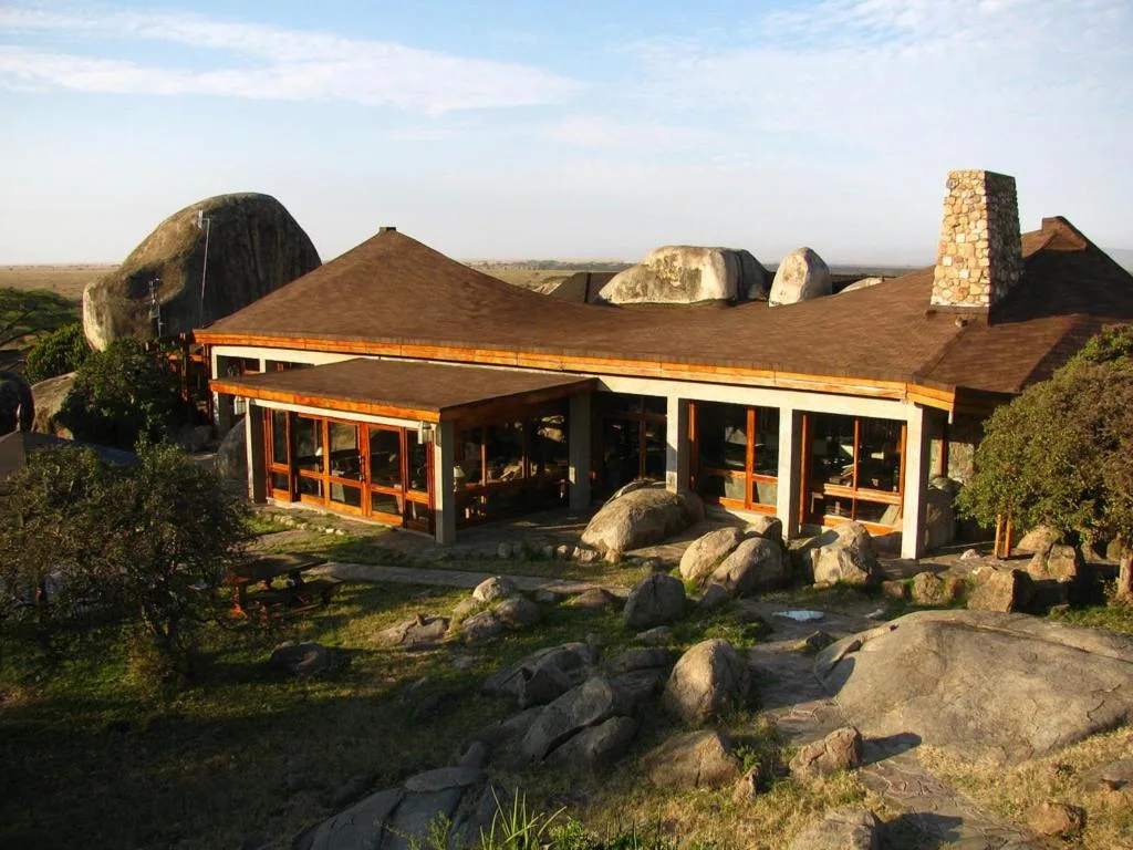 Exterior view of Lobo Wildlife Lodge built into giant granite kopje boulders in Serengeti.