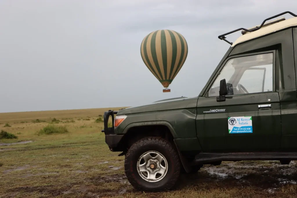 A hot air balloon floating over the plains on a serengeti balloon safari package.