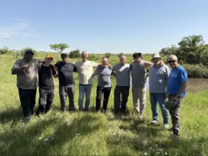 A friendly tourist group posing together on a serengeti group joining safari package.
